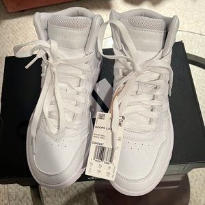 white women’s adidas high tops with tags. Never been worn.
